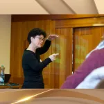 Dozent erklärt den Einsatz von NLP-Techniken in der Raucherentwöhnung und Hypnosetherapie während eines Fachvortrags.